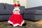 Baby girl with christmas dressing and seating on carpet