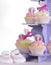 Baby girl cupcakes and booties on purple cupcake stand