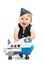 Baby girl dressed as stewardess with airplane toy