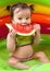 Baby girl eating watermelon