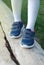 Baby girl Foot in Sport Boots Walking on Wood. Going tu future. Parenting and Educational.