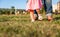 Baby girl learning to walk over a grass park