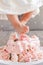 baby girl legs feet stepping in cake during her birthday celebration
