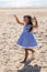 Baby girl with long hair in striped blue dress