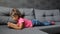 Baby girl lying on sofa with tablet. Little girl lying playing on tablet