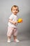 Baby girl with orange maraca.