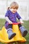 Baby, girl and outdoor on rocker with smile on grass for learning, game and development in family garden. Youth child