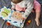 Baby girl playing with her textile book. Page with felt frog and snail. Woolly toys. Baby development. Educational toys.