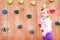 Baby girl playing next to a climbing wall