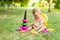 Baby girl playing with a pyramid on the lawn in the summer, play in the fresh air, the concept of early development of children up