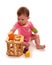 Baby girl playing with wooden shape sorter