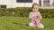 Baby girl portrait. Lovely playing at outdoor looking at camera smile 9 months happy baby playing. Lovely baby girl sit