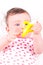 Baby girl with rattle teether toy.