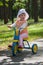 Baby girl rides tricycle