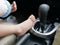 Baby girl`s feet being put next to a gear of a driving car