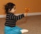 Baby Girl Shaking a Wooden Rattle