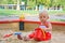 Baby girl sitting playing in a sandbox