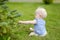 Baby girl sitting on a reen grass