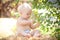 Baby girl sitting on straw