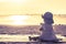 Baby girl sitting on the tropical beach and enjoys golden sunset