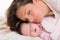 Baby girl sleeping with mother care near