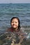 A baby girl is swimming on the beach with happy faces