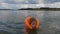 Baby girl swims in the lake in an inflatable vest