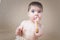 Baby girl tasting a wooden honey scoop