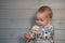 Baby girl wearing clothes with Christmas print playing with lights