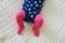 Baby girl wearing pink tights and colorful onesie