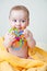 Baby Gnawing Multicolored Toy on Yellow Towel