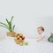 Baby goes to a bowl with apples