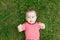 Baby on the grass or green lawn, baby walking outside in the summer, place for text