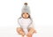 Baby in grey knitted hat on white background