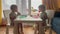 baby group eating at the table in kindergarten. happy family kid dream concept. baby twins learning to eat sitting at