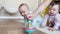 Baby group playing spinning top toy. kindergarten a happy childhood concept. Baby twins with mom play toy whirligig