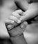 Baby hand holding mother\'s finger