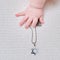 Baby hand and Jewish religious symbol is the star of David, close-up. Children fingers and an object on a white background