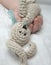 Baby hand with knitted rabbit