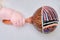 Baby hand and percussion musical instrument, close-up. Children fingers and an object on a white background