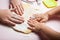 Baby hands knead the dough, close-up