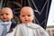 Baby heads display various items of clothing