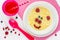 Baby healthy breakfast - sweet corn porridge with berry in shape