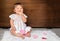 Baby with hearts on wooden background