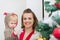 Baby helping mother decorate Christmas tree