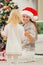 Baby helping mother decorate Christmas tree