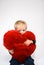 Baby hugging a plush heart