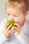 Baby, hungry girl and eating apple with thinking, learning and nutrition for growth in childhood at family home. Infant