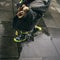 Baby kid with spotted boots playing over rain puddles in urban landscape