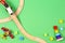 Baby kid toys background. Toy train, red airplane, wooden stacking pyramid tower and colorful blocks on light green